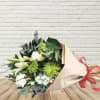 Beautiful mix of white and green winter flowers, with seasonal greens and