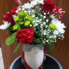 4 white daisies, 2 red roses,3 greens button, 3 stem of red