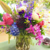 Exotic colorful flowers in a glass cylinder vase. 