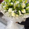 Introducing our exquisite bouquet of white roses and lilies, a true embodiment