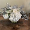 White hydrangea, white roses and silver adornments will add sparkle to anyone&rsquo;s
