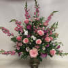 An monochromatic assortment of pink flowers. Urn may not be available -