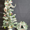 A set of a Christmas tree in a pot decorated with trucks