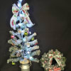 A set of a Christmas tree in a pot decorated with trucks