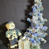 Modern day snowman scene with gifts and trees