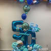 Arrangement of balloons with number and 4 balloons inflated with helium