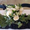 Beautiful white roses, hydrangea, alstroemeria, carnations and greens in a silver plastic