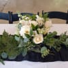 Beautiful white roses, hydrangea, alstroemeria, carnations and greens in a silver plastic