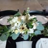 Beautiful white roses, hydrangea, alstroemeria, carnations and greens in a silver plastic