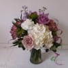 Light purple tone roses bland in with white and cream flowers