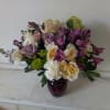 Light purple tone roses bland in with white and cream flowers