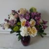 Light purple tone roses bland in with white and cream flowers