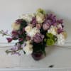 Light purple tone roses bland in with white and cream flowers