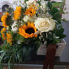 Stunning combination of large sunflowers and white rose in vintage hand tied