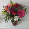 Beautiful fresh deep bright burgundy daisies, various roses and sparkly pink and