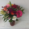 Beautiful fresh deep bright burgundy daisies, various roses and sparkly pink and