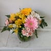 Beautifully lined pink/yellow mix of roses and spring flowers in a vase