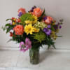 Beautiful blush mix of orange roses, alstroemeria, yellow cushion pompons, purple stuck
