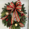A fresh wreath decorated for the Holidays.