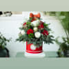 This beautiful tree is created with christmas greenery, roses, a variety of