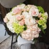 Grand arrangement of blush hydrangeas roses and spray roses in a glass
