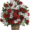 A large basket of red roses combined with the trumpet shaped blooms
