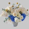 Classic and Beautiful, this arrangement whispers luxury. blue , yellow,whites and creams