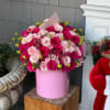 A vibrant arrangement of hot pink roses and mixed flowers in a