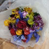 Cheerful bright mix of roses and other flowers in hand tied bouquet