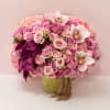 A blend of pink &amp; hot pink roses topped off with orchids