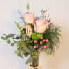 This sweet arrangement comes with three roses and seasonal greenery with other