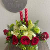 Distinctive Christmas centerpiece made of fresh cut roses, white Asiatic lilies, green