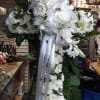 An all white tribute, this white cross funeral spray is pure and
