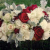 Red, white, and Cream roses mixed with white hydrangeas and gray accents