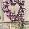  This unique heart-shaped standing spray is made up of an assortment