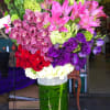 This is an exceptional presentation of Roses, Lisianthus, Orchids, Lilies, Exotic Greens