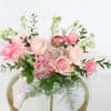 This brilliant arrangement of pink flowers brings some sunshine and vibrant color