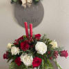 Elegant Christmas centerpiece made of fresh cut white and red roses, green