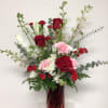 8 inch tall red glass swirl vase is arranged with white hydrangea