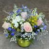 A beautiful combination of pastel pinks and blue blooms arranged with stock