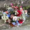 Refreshing mixed bouquet featuring blooms in red, blue and white. Airy movement