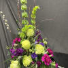 This arrangement is made up in a decorative tin with bells or