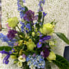 This low dish arrangement is made up of foxglove, roses, iris, and