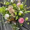 Tall vase arrangement with stock, roses, lisianthus, and lupine. 