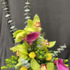 This arrangement is made up of eucalyptus, orchids, calla lily, and hypericum