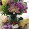An arrangement of seasonal flowers and assorted pastries of the day (actual