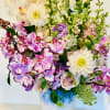 Like a mini English garden, this charming arrangement features a whimsical cluster