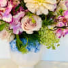 Like a mini English garden, this charming arrangement features a whimsical cluster