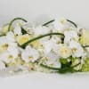 An arrangement with orchids, roses, hydrangeas, and greenery