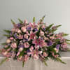 A beautiful arrangement with pink flowers and just a touch of lavender.